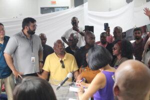 Mayor Olivia Chow behind a podium speaking to a man in the crowd in Revivaltimes Tabernacle Church