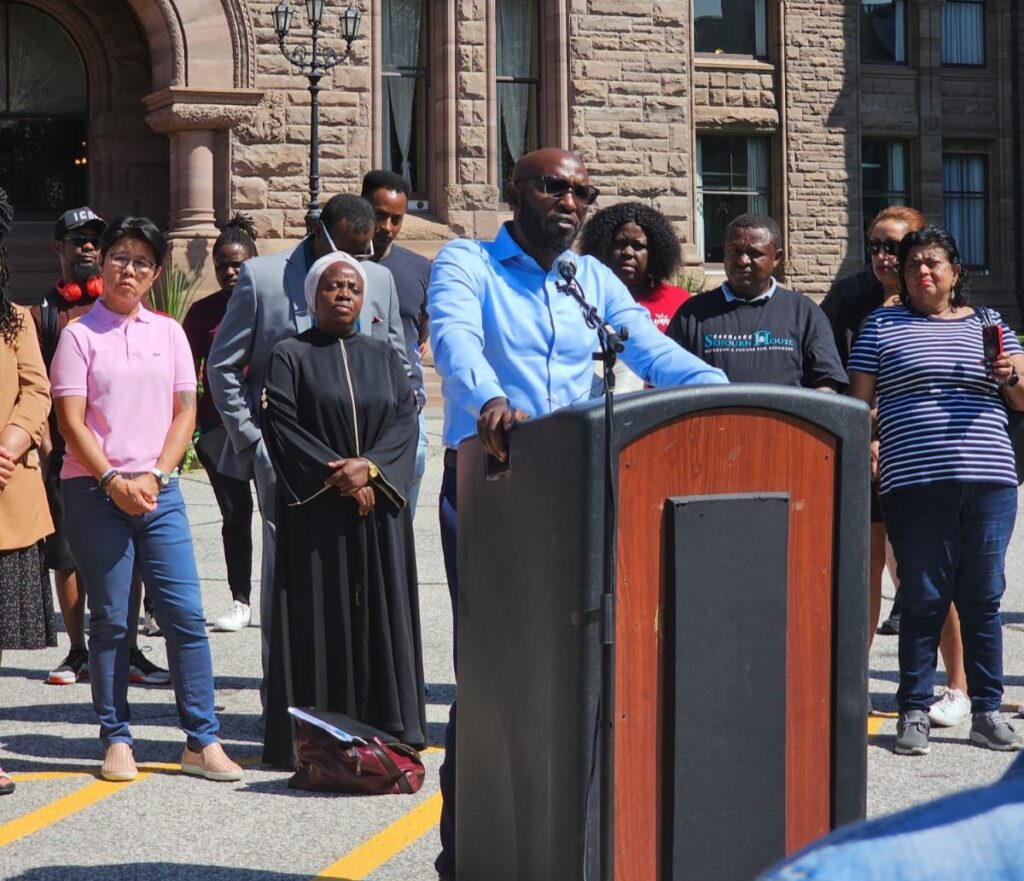 Kizito Musabimana addresses a crowd outside of Ontario’s legislative headquarters.