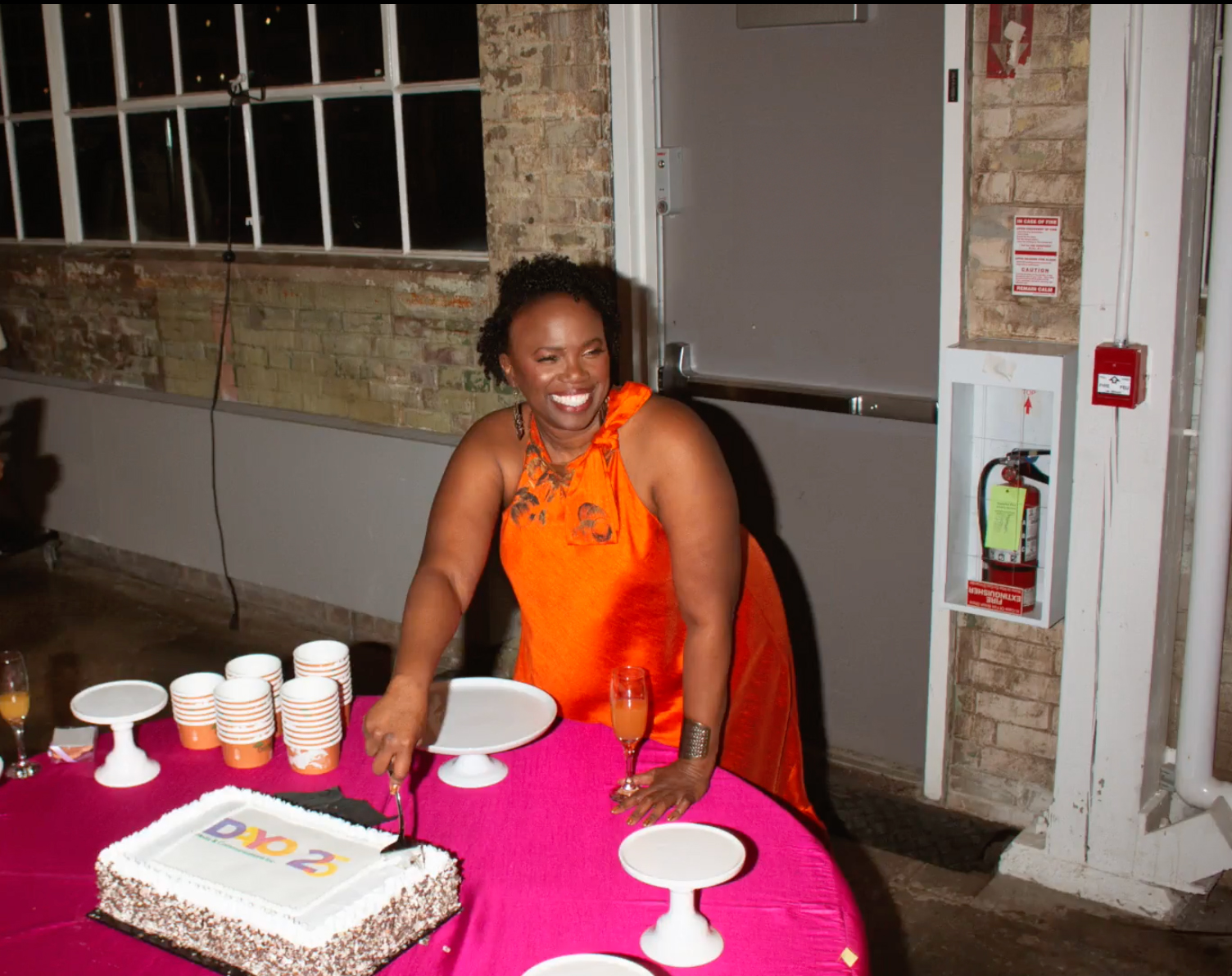 Dayo Kefentse cutting a cake